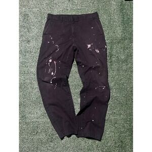 Vintage black work pants with unique paint splatter details.